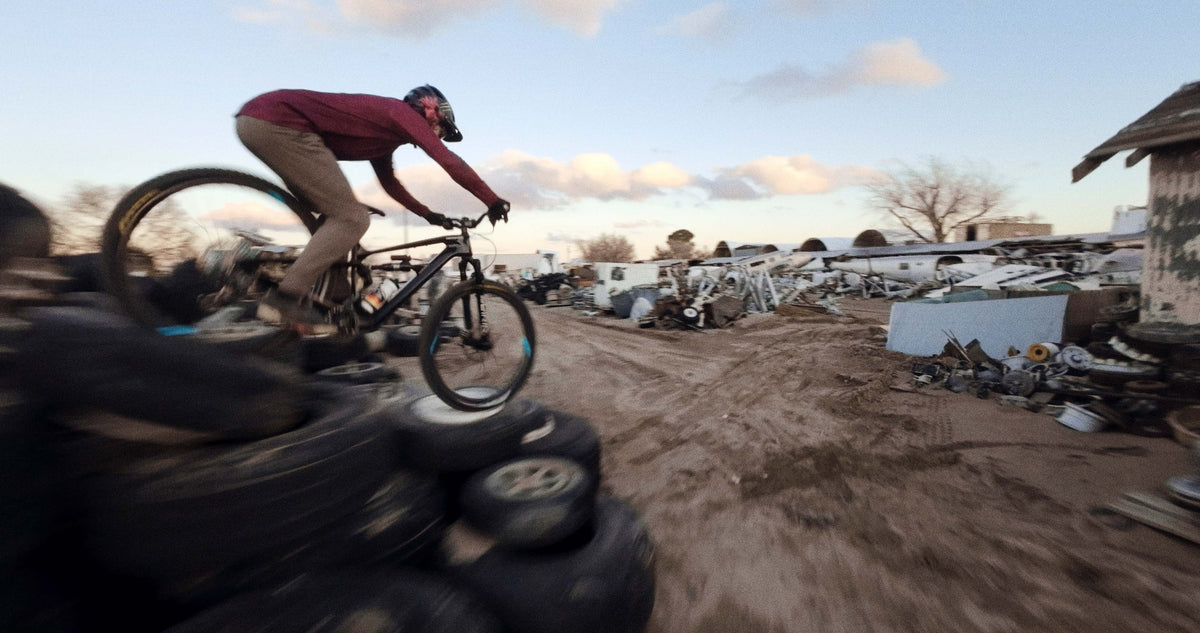 Mountain Biker Jumping off Debris with Carbon Fiber Wheels