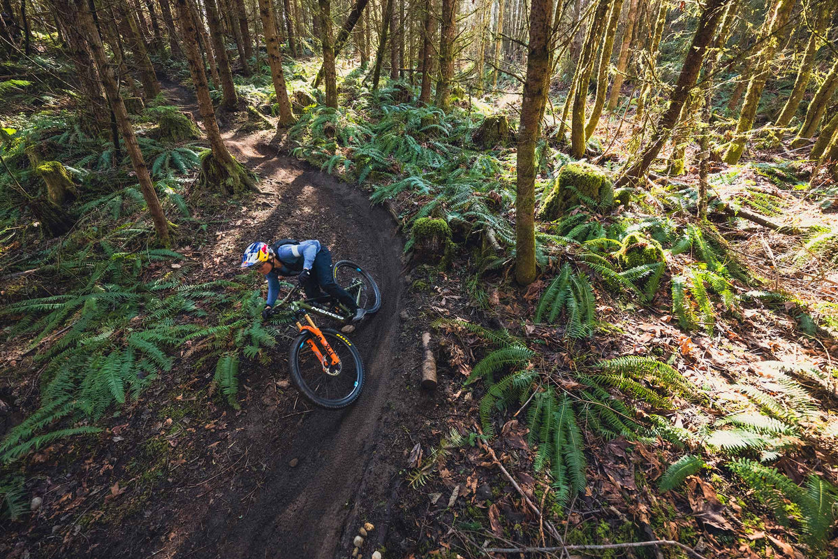 Mountain Biker Riding Enduro MTB Wheels Through Forest